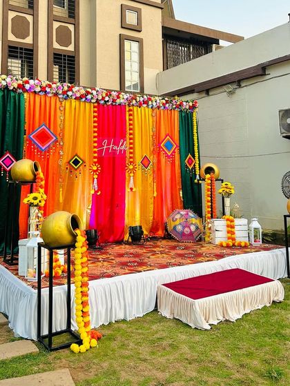 A wider angle of the multi-color outdoor Haldi stage. This setup is perfect for larger gatherings and provides a vibrant backdrop for all your Haldi function photos.