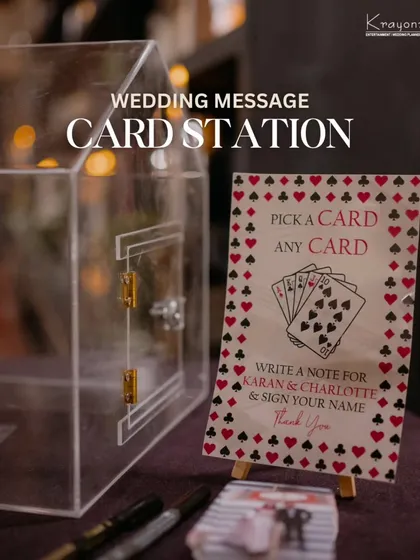 The wedding message card station, complete with a clear box to collect the notes and a sign inviting guests to "Pick a card, any card."