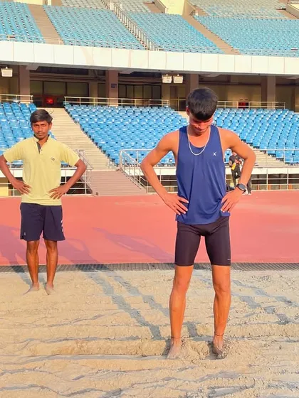 Athletes standing ready for the next set of drills in the sand pit. The focus and determination on their faces show they are prepared for the hard work ahead.