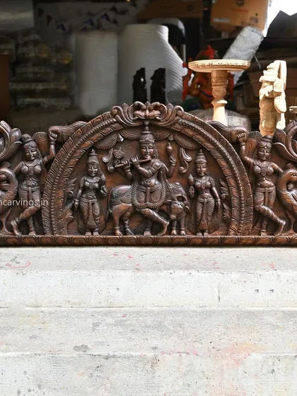 A beautiful 54-inch wall panel of Lord Krishna playing his flute, framed by a Kirthi Mukh arch design. The composition, which includes attendant gopis and peacocks, creates a pastoral and divine scene.