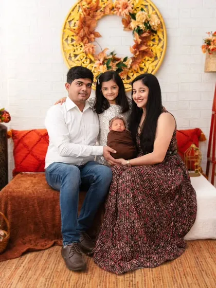 The family is now complete. This portrait includes the proud big sister, creating a beautiful memory of the moment a family of three became a family of four.