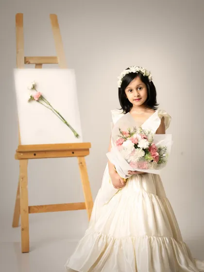 She's a wildflower in a field of roses. This elegant portrait captures the unique beauty and confidence of a five-year-old.