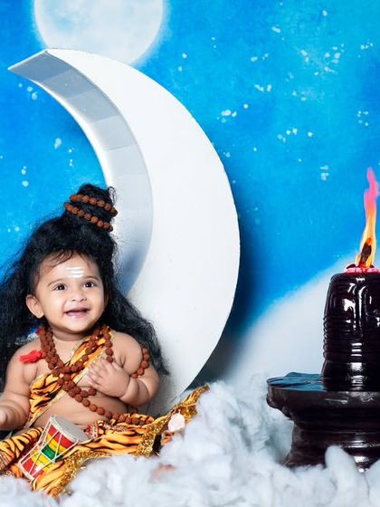 This little Shiva is all smiles, sitting peacefully next to a lingam with a flame.