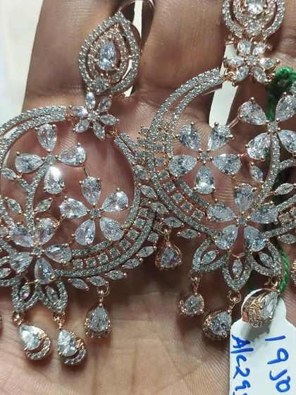 A large pair of floral-themed American Diamond chandbali earrings with a rose-gold polish. These are very glamorous and eye-catching.