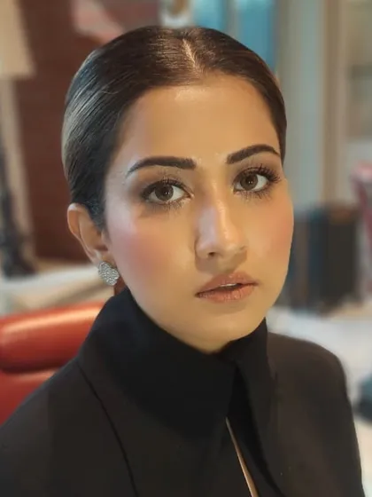 We created this sophisticated look featuring a soft brown smokey eye and a perfectly sculpted complexion. The hair is styled into a sleek, low bun, ideal for a polished and professional appearance.