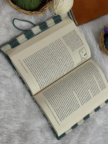 My crochet cover on an open book. It protects the cover and spine while you're reading.