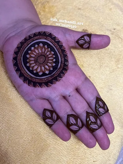 If you prefer a modern and minimalist aesthetic, I can create a design that is both simple and striking. This piece features a bold, shaded mandala on the palm with simple leaf motifs on the fingertips.