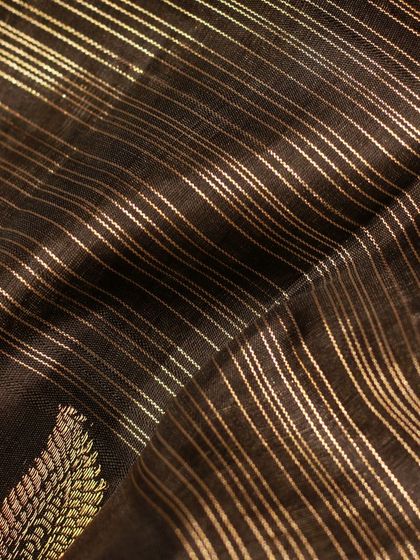 The fine gold lines on the black Kanjivaram create a beautiful texture and shimmer.