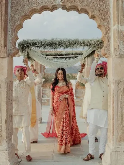 A stunning shot of the bride's entry through a beautiful stone archway at a destination wedding.