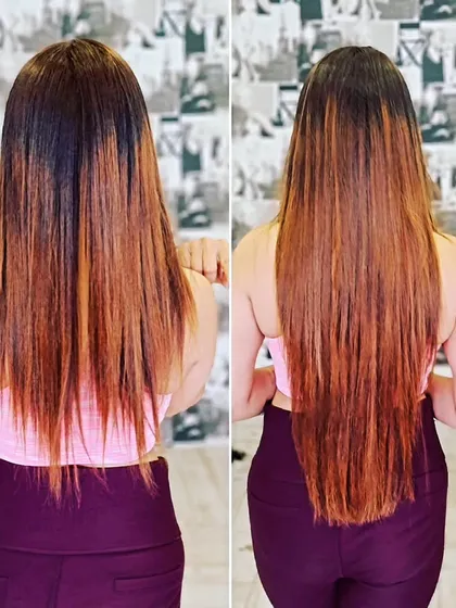 This back view demonstrates a beautiful color melt. The extensions help create a smooth transition from a darker root to lighter, coppery ends, adding length at the same time.