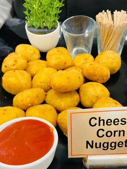Our Cheese Corn Nuggets are a hit with guests of all ages. These crispy bites are filled with a creamy mixture of cheese and corn, served with ketchup for dipping.