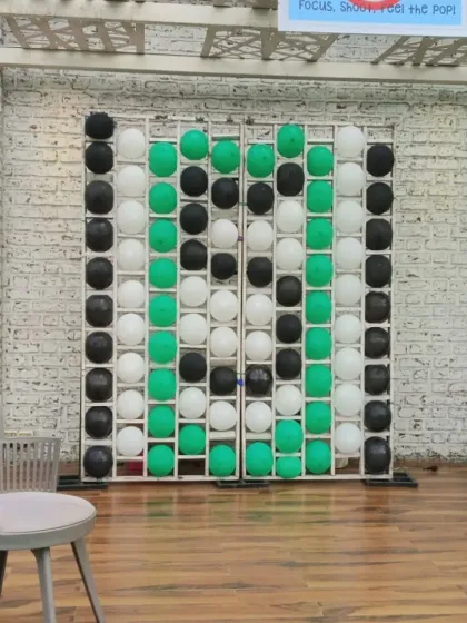 We also designed a custom "pop the balloon" game to match the football party's color scheme. This is a fun and simple carnival-style game that adds another layer of entertainment to the event.