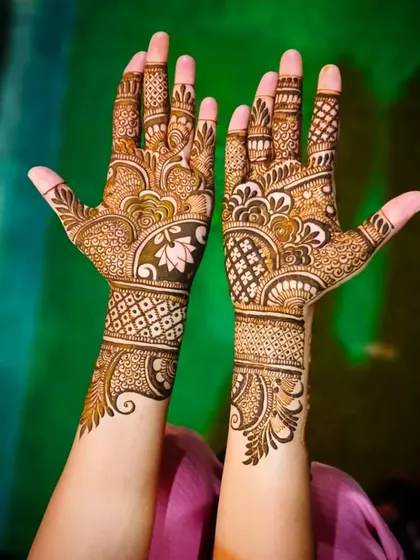 A bright and clear photo of the lotus mehandi, highlighting the intricate finger work.