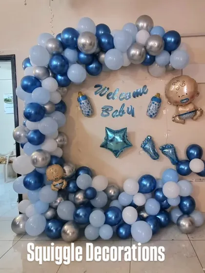 A 'Welcome Baby' balloon arch in shades of blue and silver, perfect for a baby boy's welcome home celebration.