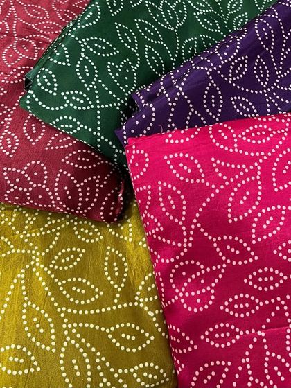 A colorful assortment of our Gajji satin prints. The silky finish and traditional bandhani-style patterns make this fabric a festive favorite for sarees, kurtas, and more.
