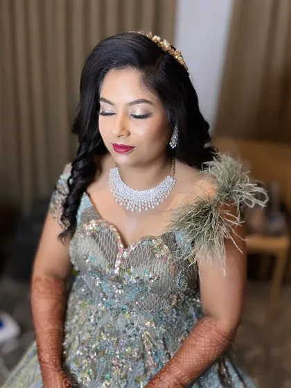Another shot of this glamorous reception look. The soft curls and sparkling hair accessory complete the ensemble.