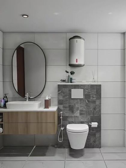 A clean and functional bathroom with a simple wood vanity, an oval mirror, and a combination of white and grey tiles. This design is timeless and easy to maintain.