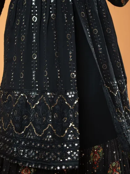 A detailed close-up of the sequin work and embroidery on the lower part of the dress.