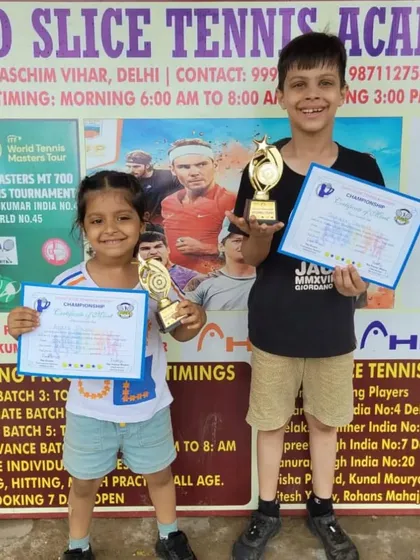 Two of our young players from different age groups showing off their trophies and certificates. We train champions of all ages at our academy.
