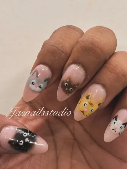 For the cat lovers! I hand-painted different cute cat faces on each nail for this adorable and unique manicure.