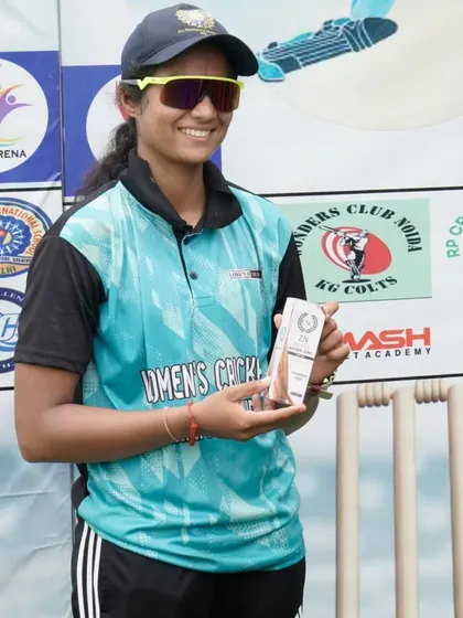 Recognizing individual brilliance within a team effort. One of our players proudly holds her award at the post-match ceremony of the Women's Cricket Championship.