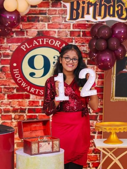 A vibrant 'Pokemon' themed birthday party, with character cutouts, a custom backdrop of the Kanto region, and red and white balloons, ready for a Pokemon battle.