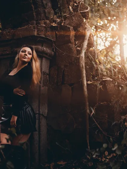 A photo taken in the Goan forest at sunset. The golden light and natural setting create a beautiful, atmospheric portrait.