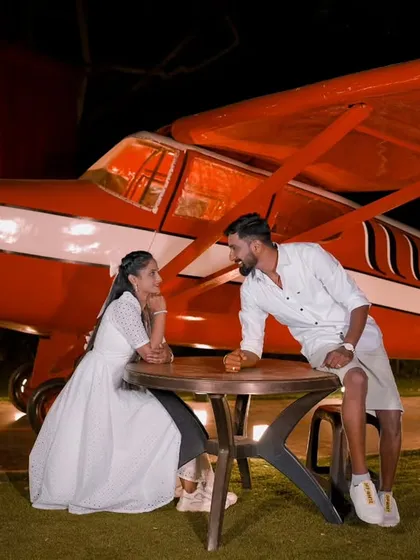 A unique and adventurous night shoot with a vintage airplane prop. The lighting creates a dramatic and cinematic feel for your pre-wedding photos.