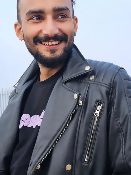 A smile and a leather jacket. My brand is a balance of edgy style and positive energy.
