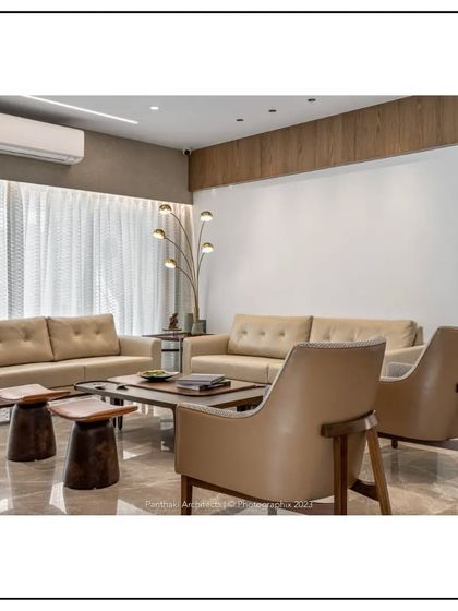 In this living space, we paired contemporary sofas with rustic wooden stools as side tables, demonstrating our eclectic style. The design balances modern clean lines with natural, textured elements for a unique and comfortable feel.