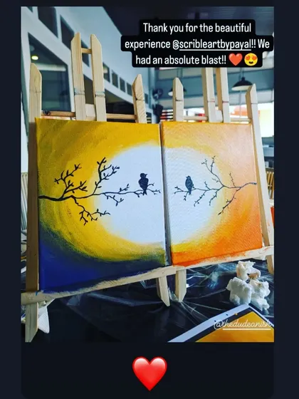 A beautiful diptych painting of two lovebirds on branches, created by a couple at one of my workshops.