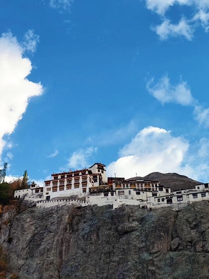 A closer look at a Ladakhi monastery, showcasing the intricate architecture against a perfect sky.