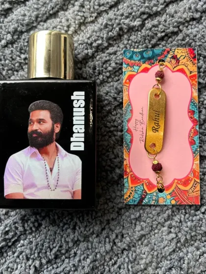 A unique Rakhi gift for a fan. This combo features a perfume bottle customized with a photo of his favorite star, paired with a personalized Rudraksha rakhi.