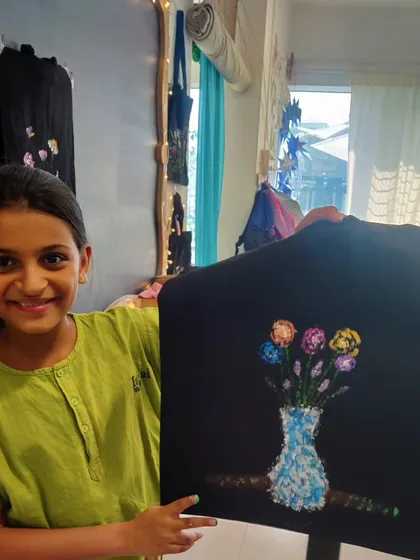 This student painted a lovely vase of flowers on her tote bag, using a pointillism-like technique to create texture. It's a wonderful example of applying fine art techniques to a craft project.