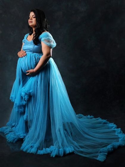 A classic studio portrait in my sky blue maternity gown. The long, flowing train adds a touch of elegance and drama to this beautiful pregnancy photo.