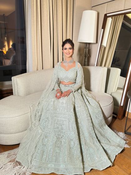 This bride chose a beautiful pastel lehenga for her event, and we paired it with an elegant textured updo. The hairstyle is sophisticated without being severe, perfectly matching the soft and dreamy vibe of her outfit.