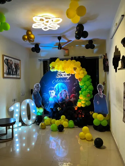 Bringing the magic of Hogwarts home with this detailed Harry Potter theme for a 10th birthday. The decor includes a themed backdrop, house-colored balloons, character cutouts, and a large light-up '10' for memorable photos.