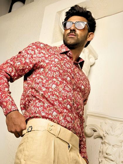 A confident pose in the red floral shirt. This piece is designed for the man who is not afraid to let his style speak for him.