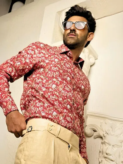 A confident pose in the red floral shirt. This piece is designed for the man who is not afraid to let his style speak for him.