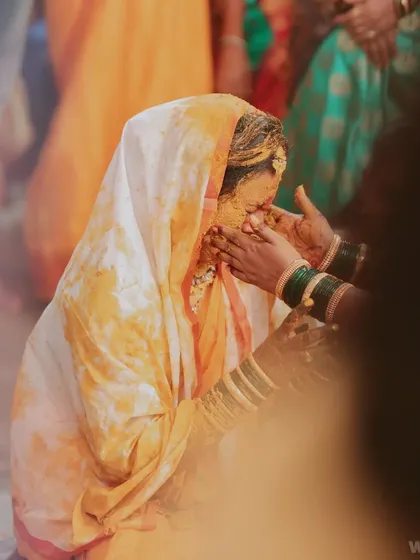 An emotional and powerful moment from a Haldi ceremony, as turmeric paste is applied to the bride. I capture these raw, heartfelt rituals.