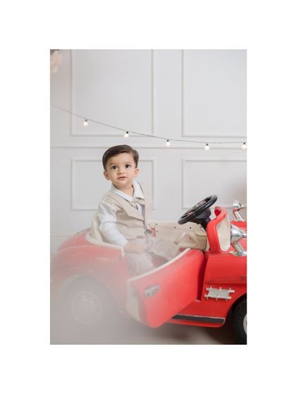 A dreamy, soft-focus shot of the birthday boy in his vintage car, adding an artistic touch to his milestone session.
