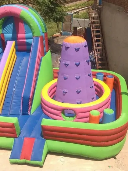 This is a multi-activity inflatable. It has a slide, a small climbing wall, and pop-up obstacles all in one, providing a variety of fun activities.