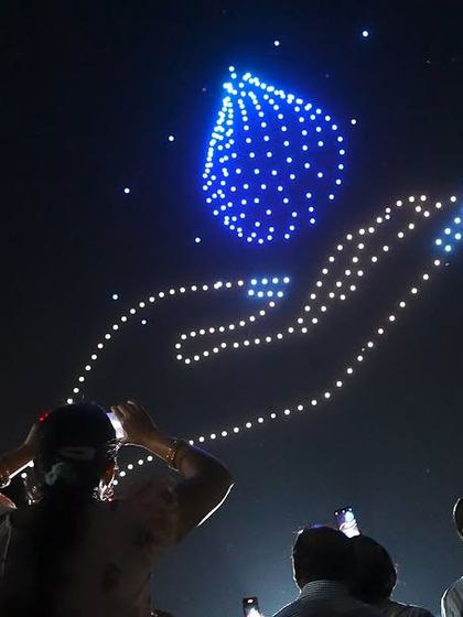 A hand holding a water droplet, a formation from our show for the Jal Jagar Maha Utsav in Chhattisgarh. We used our platform to spread the important message of water conservation.