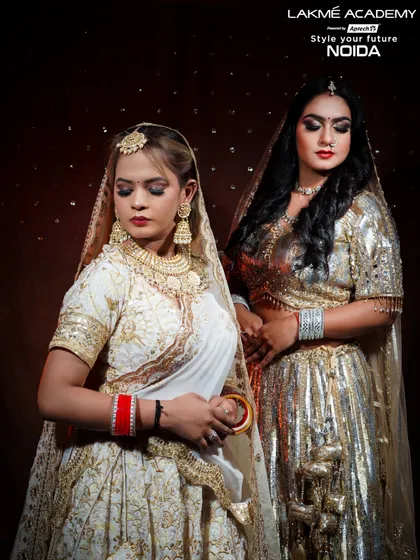 Two distinct bridal styles, one frame. This image showcases our students' versatility in creating both a traditional white and gold look and a bold, modern glam look.