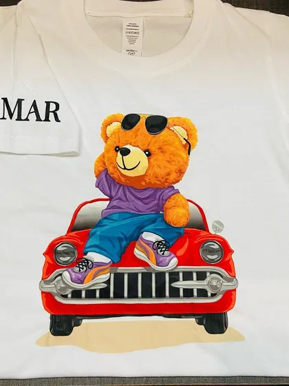 A close-up of our personalised teddy bear t-shirt, with the name 'Samar' on the sleeve. A great gift for birthdays or just for fun.