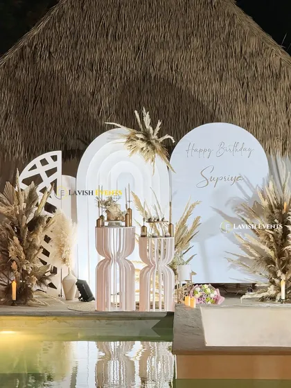 A high-quality shot of our poolside boho setup, showing the intricate details of the layered backdrops and the natural floral arrangements.