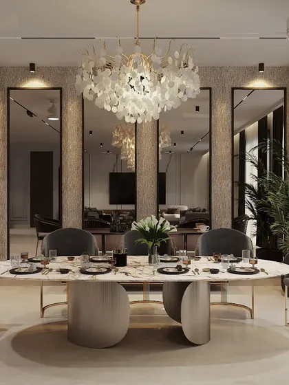 An elegant dining space designed for memorable gatherings. We used a stunning shell-petal chandelier as the centerpiece, complemented by a marble-topped oval table and velvet-upholstered chairs with brass accents for a touch of opulence.