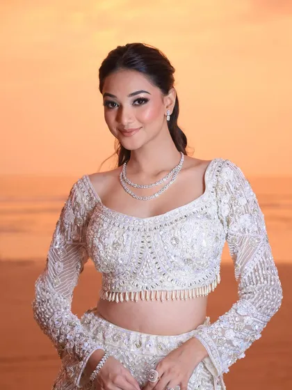 A beachside engagement calls for a sun-kissed glow. I designed this fresh and luminous look with soft, glittery eyes and a relaxed ponytail to perfectly suit the romantic sunset backdrop and her diamond jewelry.