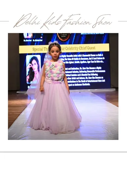 A little princess takes the stage in a beautiful pastel gown. The large screen in the background announces our celebrity chief guest, highlighting the professional and high-profile nature of the event.
