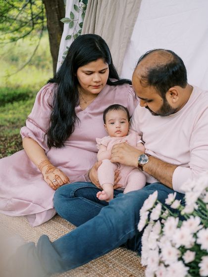 A family sitting together with their three-month-old. Capturing these early family portraits is so important as they change so fast.
